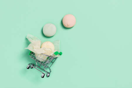 Food mint concept. Tasty marshmallows wrapped in paper transported on a shopping cart. Flat lay, top view.の写真素材