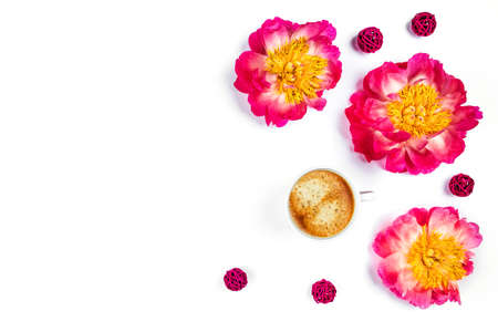 White cup of coffee and beautiful peonies on isolated white desk. Flat lay, top view, copy space.