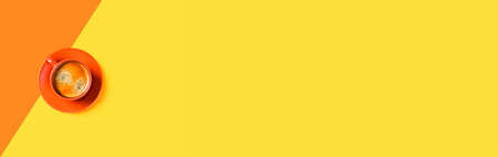 Web-banner with orange and yellow background with cup of tasty coffee. Flat lay, top view, copy space.の写真素材