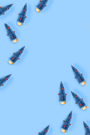 Christmas and New year pattern with blue background with christmas trees and red balls. Flat lay,...
