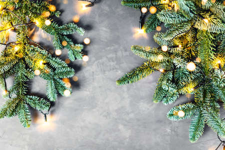 Christmas and New year composition with fir brunches on gray table.