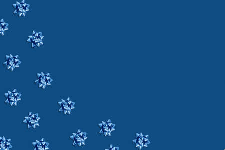 Christmas and new year pattern. Celebration picture. Classic blue background with blue bright bows....