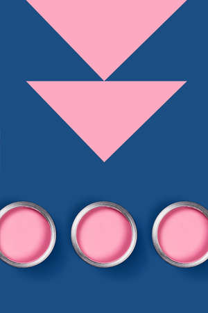 Renovation of apartments. Vertical geometric composition. Three pink jars with acrylic paint on classic blue background. Place to text.の写真素材