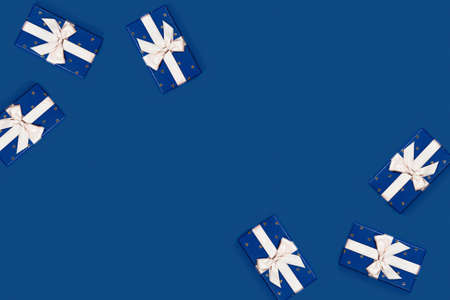 Classic blue background with 6 blue gift boxes. Flat lay, top view, place for the text.の写真素材