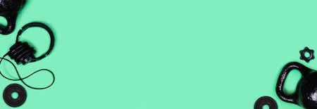 Sports web banner. Kettlebells and dumbbells on mint green background. Flat lay, top view, copy space.の写真素材