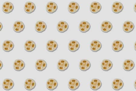 Zero waste concept. Natural sponge pattern on yellow background. Flat lay, top view.の写真素材