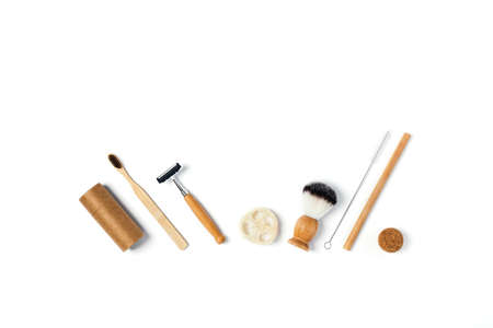 Zero waste concept. Natural bamboo toothbrush, bamboo ear sticks, razor, paper tube, wooden drinking...
