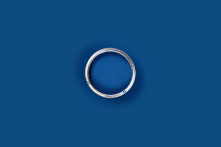 Repair concept. Classic blue background with one paint can, central composition. Flat lay, top view,...