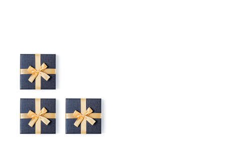 Holiday card. Grey gift boxes with gold bow on isolated white background. Flat lay, top view, copy...