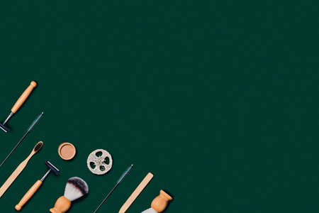 Zero waste concept. Natural bamboo toothbrush, razor, natural sponge on green background. Flat lay,...