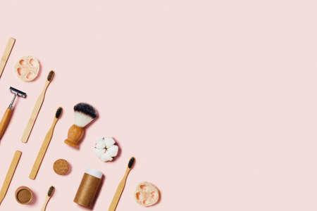 Zero waste concept. Natural bamboo toothbrush, bamboo ear sticks, razor, paper tube, wooden drinking...