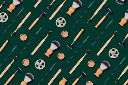 Zero waste concept. Natural bamboo toothbrush, razor, natural sponge on green background. Flat lay,...