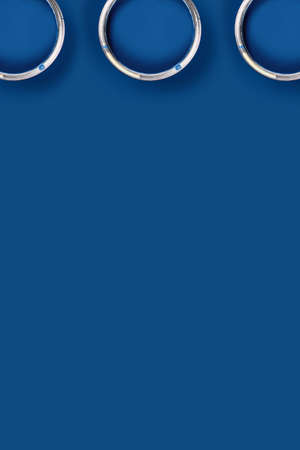 Vertical picture. Classic blue background with three blue paint cans. Flat lay, top view, copy...
