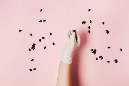 Hand in medical glove with tablet on pink background. Photo on the theme of coronavirusの写真素材