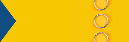 Repair concept. Yellow background with three color paint cans. Flat lay, top view, copy space.の写真素材