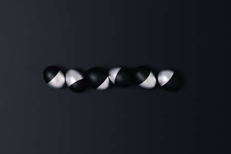 Six black and silver Easter eggs on a dark grey background. Flat lay, top view, copy space.