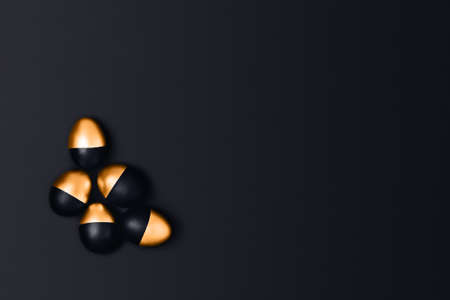 Six black and golden Easter eggs on a black background. Flat lay, top view, copy space.の写真素材