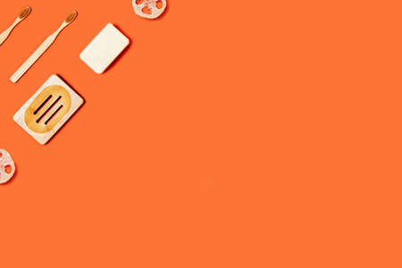 Ecological accessories for body care: natural sponges, soap, toothbrushes located on orange background.の写真素材