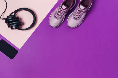 Sports equipment and shoes for women's training. Pink-purple background, diagonal composition.の写真素材