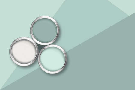 Flat lay picture with three color paint cans on tricolor pastel green background.