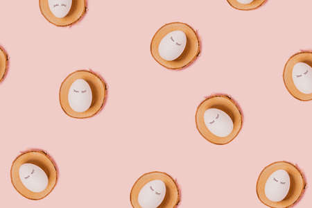 Happy Easter. White eggs with painted eyes on wooden trays on a pink background. Flat lay, top view, copy space.の写真素材