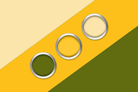 Green and yellow background with three cans of color paint, central composition. Flat lay, top view,...