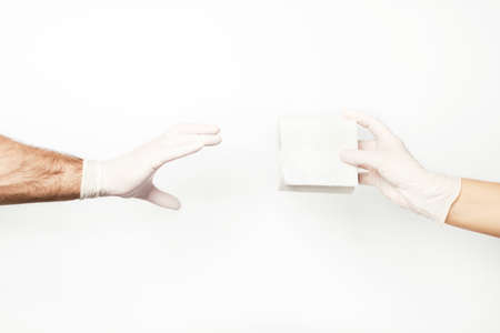 A man and a woman's hand fighting over the last roll of toilet paper.の写真素材