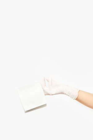 A woman's hand holding the last roll of toilet paper.の写真素材