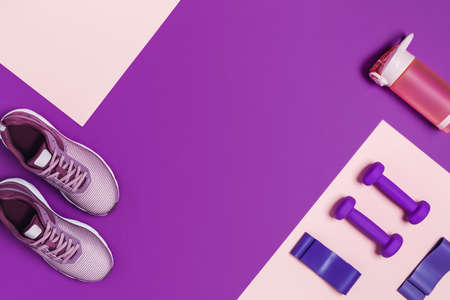 Sports equipment for women's training. Pink-purple background, diagonal composition.