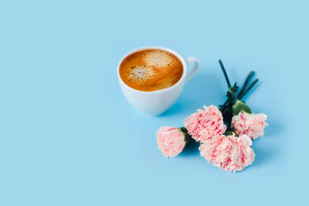 Morning cup of strong coffee with flowers on blue background.の写真素材