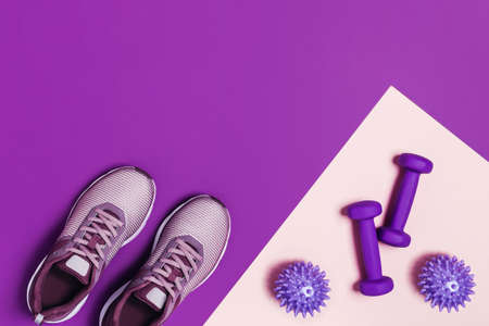 Sports equipment and shoes for women's training. Pink-purple background, diagonal composition.の写真素材