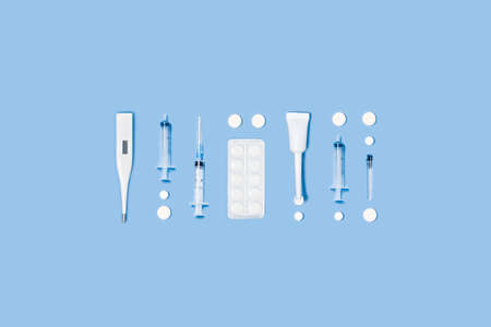 Medical central composition with different accessories on blue background.
