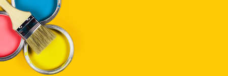 Renovation concept. Yellow web banner with three color paint jars and one brush.