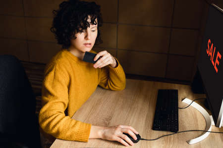 Young woman shopping online from home.