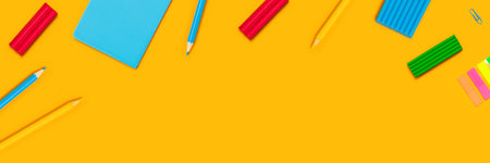 Back to school web banner. Writing materials on yellow background.