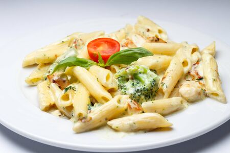 tasty pasta with broccoli and tomatoesの写真素材