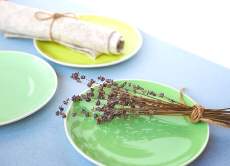 green plates on a linen tablecloth whith lavender brunch