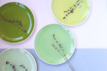 green plates and cup on a linen tablecloth whith lavender brunchの写真素材