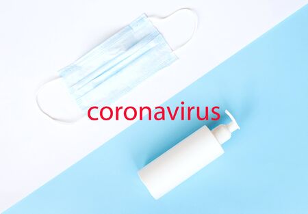 medical mask, disinfector, soap, pills on a blue background. flat lay.の写真素材