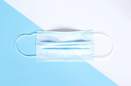 medical mask and disinfector on a blue and white background. flat lay.の写真素材