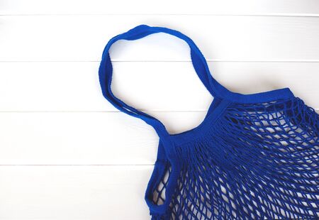 Empty blue net bag on wooden background.の写真素材