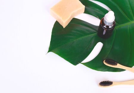 The concept of zero waste. bamboo toothbrush, solid shampoo and manstera branch.の写真素材