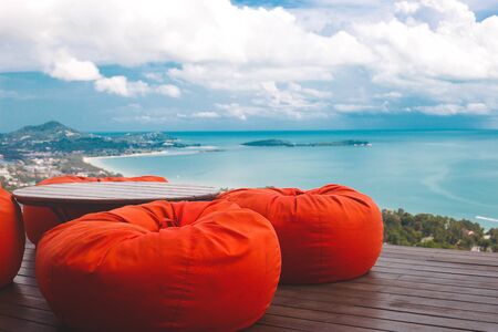 comfortable ottomans on top of a mountain with ocean views.の写真素材