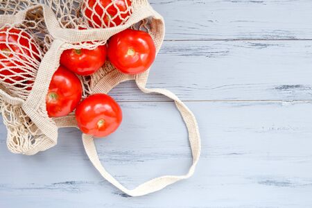 Package-free food shopping. Eco friendly natural bag with organic fruits and tomatoes. Zero waste concept.の写真素材