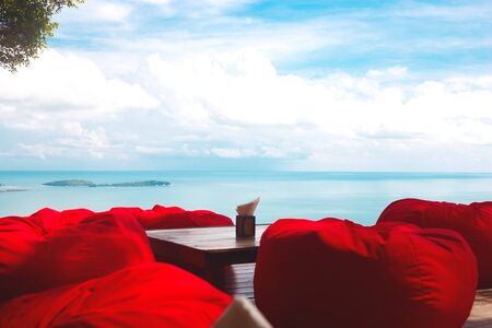 comfortable ottomans on top of a mountain with ocean views.の写真素材
