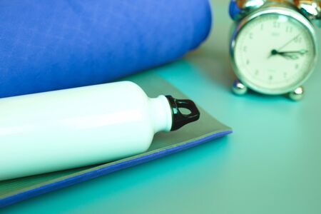 Bright blue yoga mat on a gray background.の写真素材