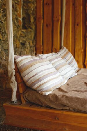 rest zone. rustic wooden hanging bed outdoors.の写真素材