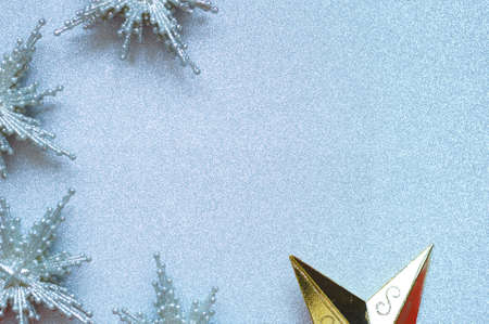 silver and gold stars christmas toys on silver background.の写真素材