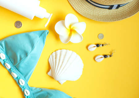 set of summer beach accessories on a yellow background.の写真素材