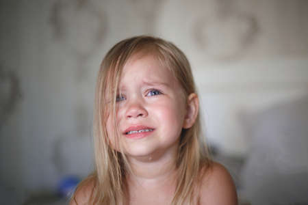 portrait of a little crying girl.の写真素材